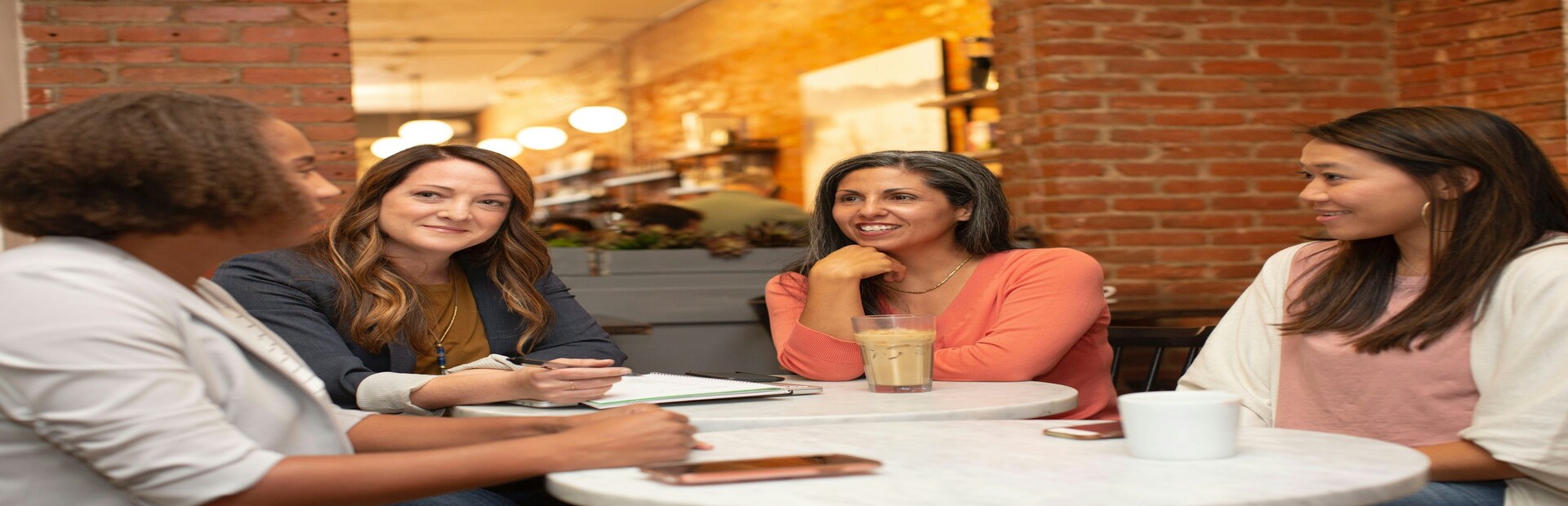 Group of businesspeople sitting at table and shaking hands